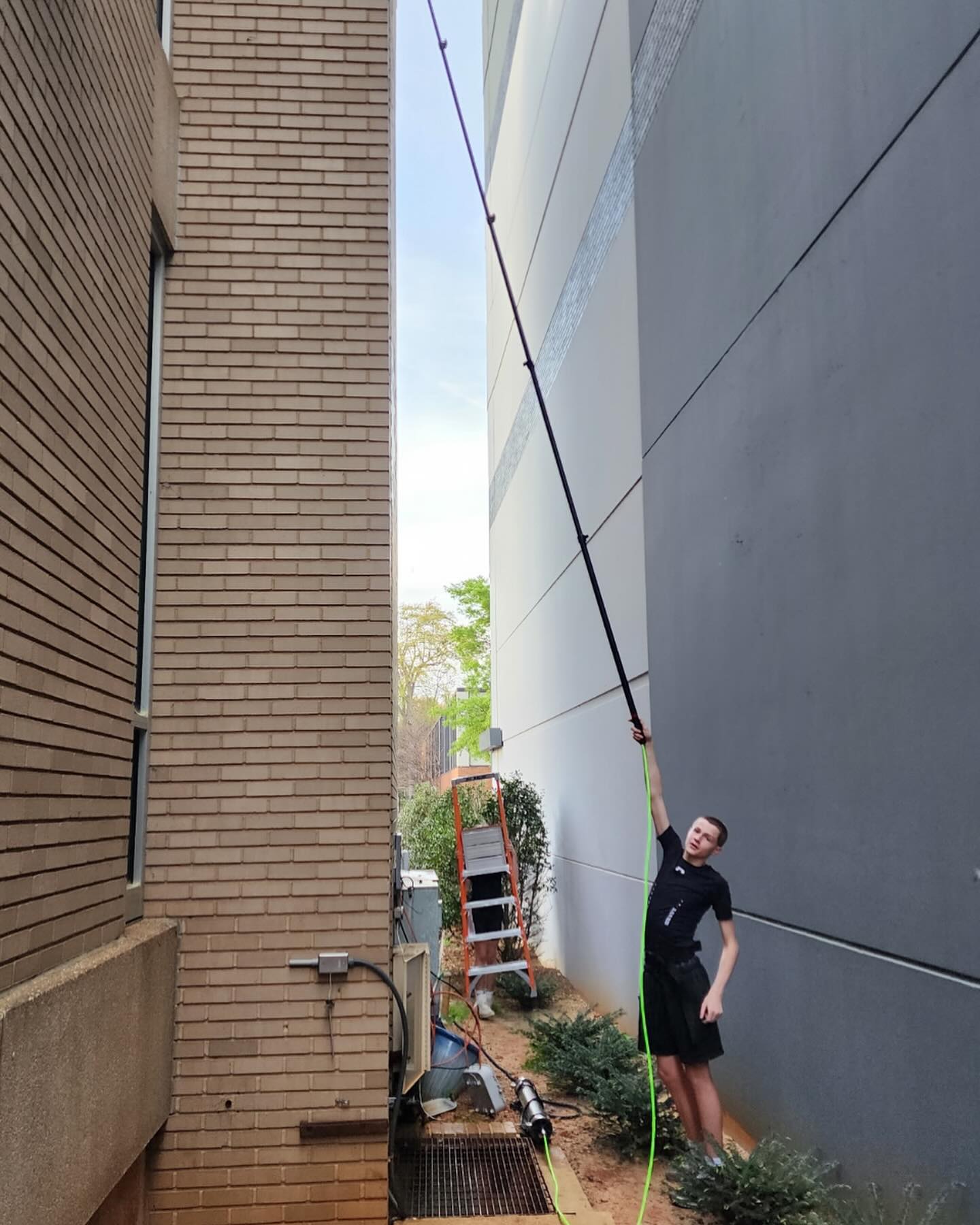 Reaching high windows with an extension pole